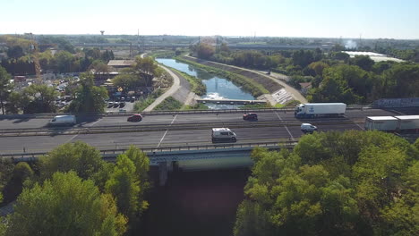 car traffic on a bridge over a river in montpellier drone aerial view. sunny day