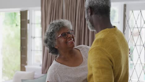 a senior african american couple dancing at home. social distancing in quarantine