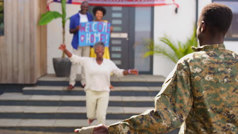 multi-generation family with parents and wife welcoming army soldier home on leave with banner