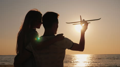 man and child play with a toy airplane