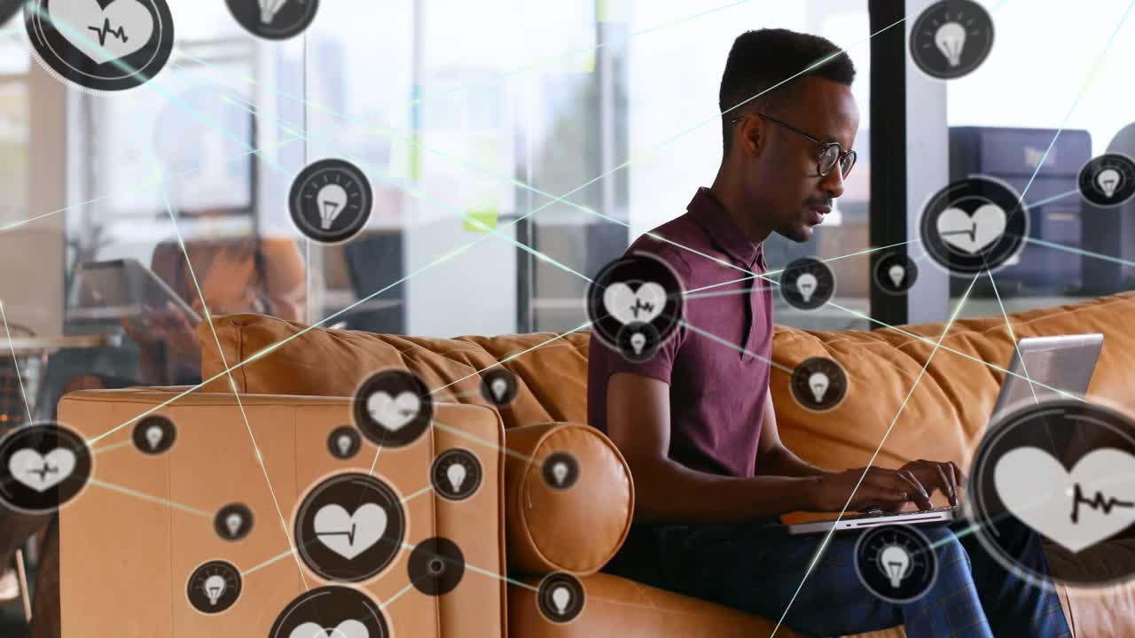 Man typing on laptop in tech office visualizing health idea pin icons expanding web obscuring view