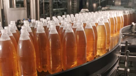 conveyor belt with bottles for juice or water at a modern beverage plant. modern production of sweet soda water