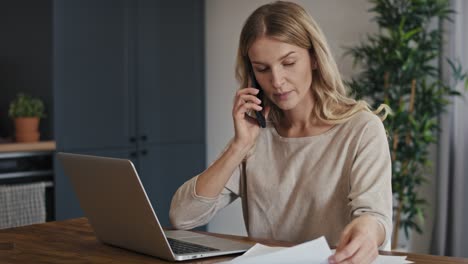 caucasian woman having financial difficulties and having phone call.