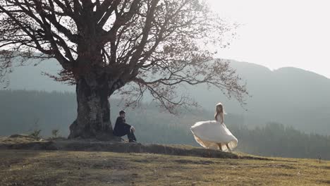 newlyweds. caucasian groom with bride on mountain slope. wedding couple. happy
