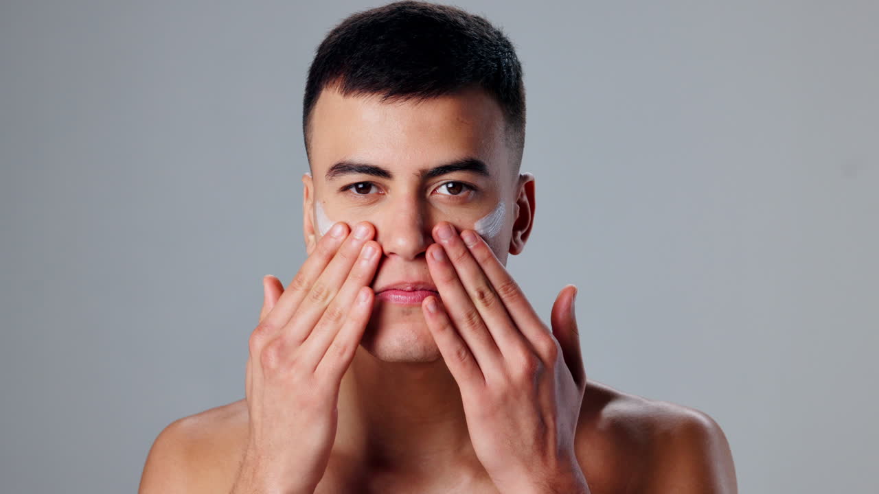 Man applying skincare to face