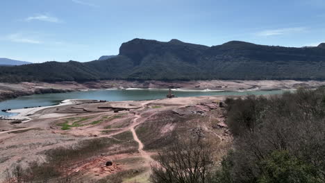 fossil fuel quarry in spain with extremely low reservoir water levels during drought