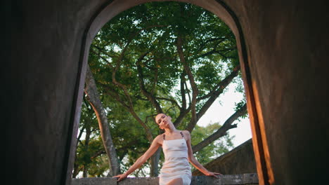 woman relaxing old fortress standing balcony view from arch. girl leaning fence