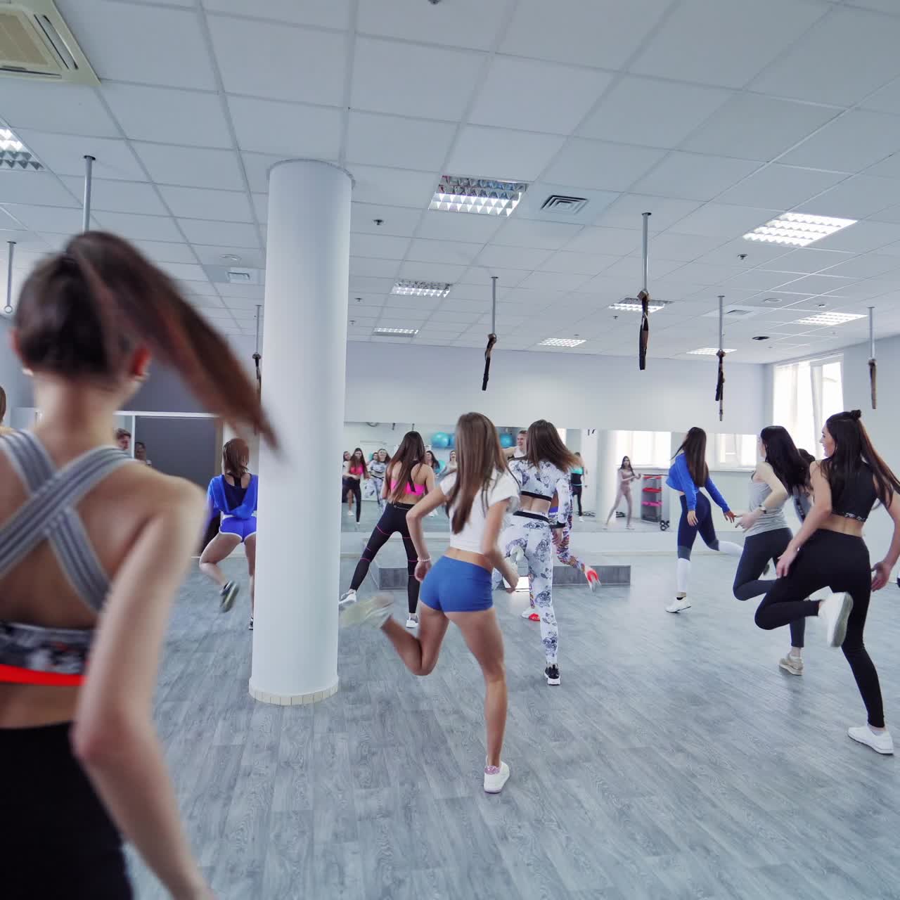 Smiling people exercising in the gym