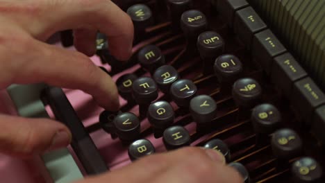 a person is typing on a vintage typewriter - close up
