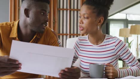 video of focused african american couple planning home budget