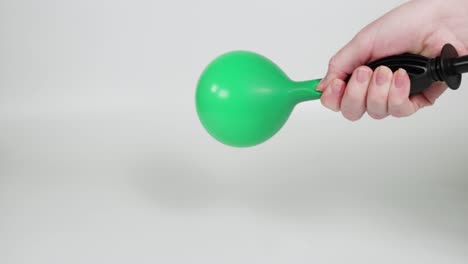 sequential inflation and deflation of a green balloon