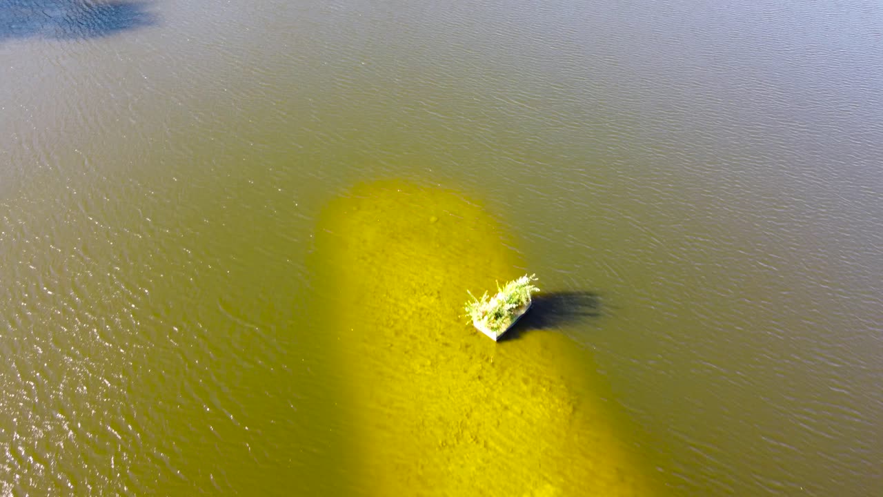 reveal shot of a little island in a lake in Norwich, England