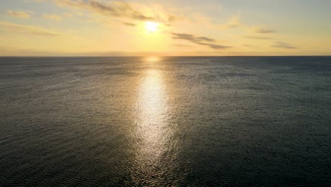 sunrise of the ocean in miami, pointing at the sun