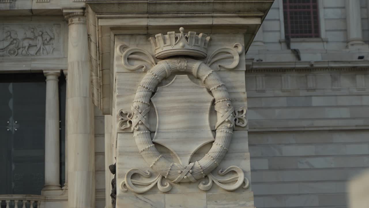Detailed Marble Carving with Crown and Crest on a Historic Building