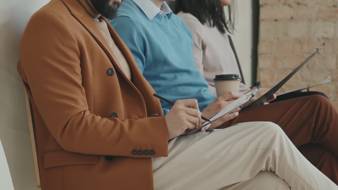 Three People Waiting for Job Interview