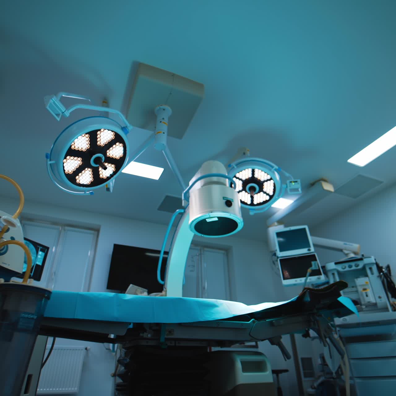 Two types of lamps illuminating the modern surgery room. Low angle view on the equipment