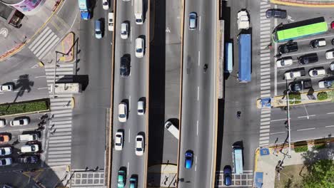 ascending aerial view from streets with flowing traffic, capturing the constant motion and expanding cityscape as the camera rises