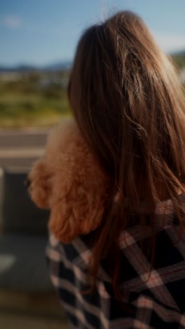 girl and dog on a balcony