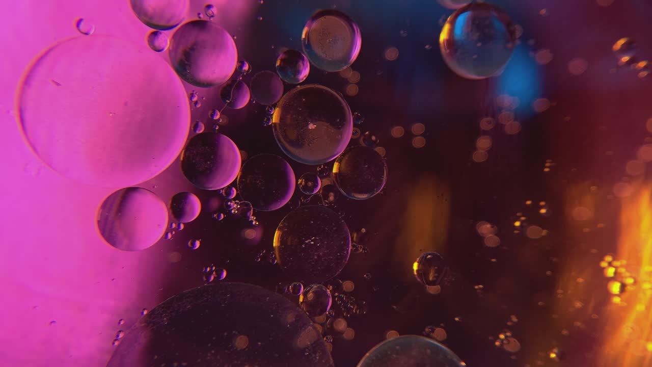 Close-up of oil bubbles in water.
