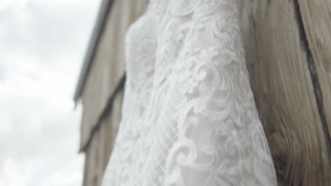 bride's white wedding dress hanging on the door