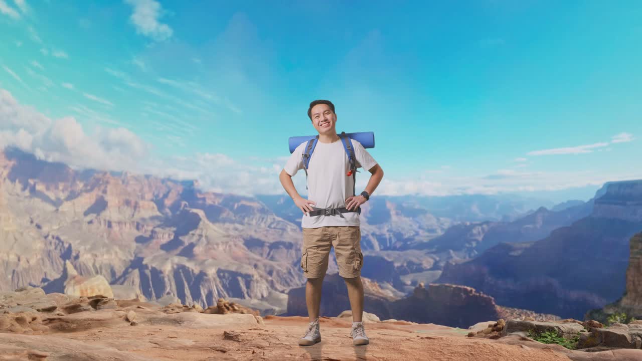 Full Body Of Asian Male Hiker With Mountaineering Backpack Smiling And Posing Arms Akimbo While Traveling At The Top Of Mountain