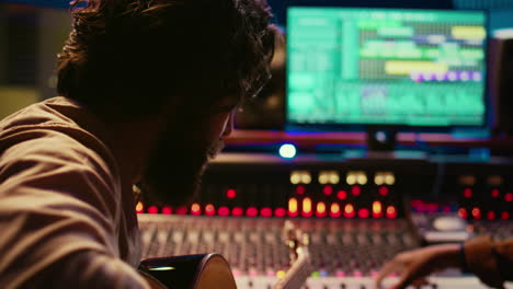 young artist songwriter composing a new song on guitar in recording session