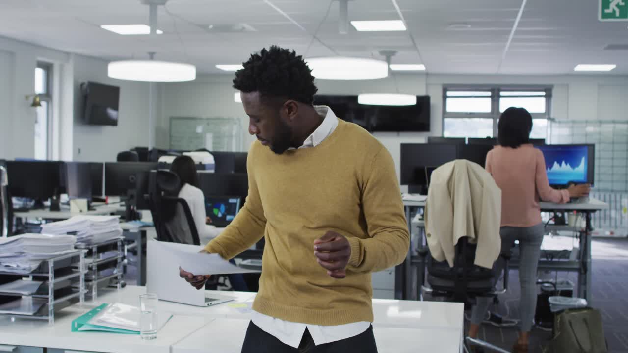 Man reading a document at office