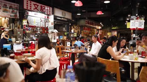 people enjoying meals in a bustling restaurant