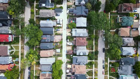 An-overhead-aerial-view-of-houses-and-homes-and-colorful-tree-tops-in-a-residential-estate-neighborhood-in-suburbs-of-Winnipeg-Manitoba