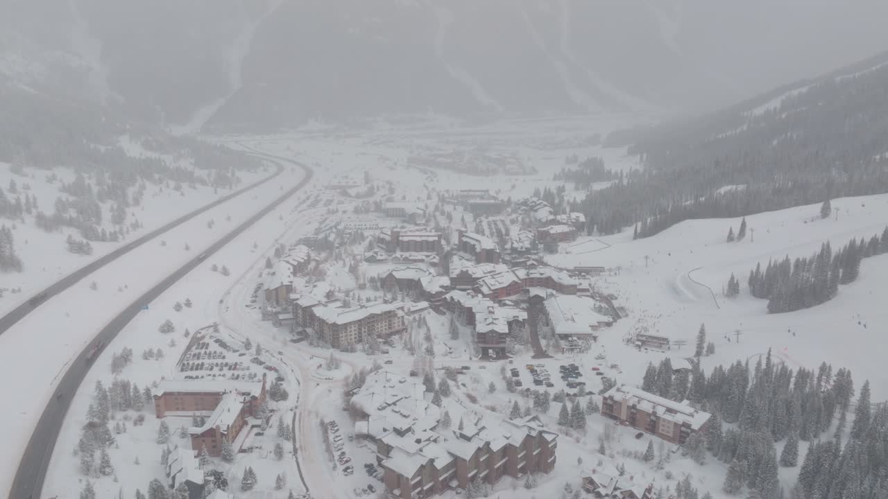 Aerial backward shot of Centre Village covered in snow after snowstorm at Copper Mountain in Colorado, USA.