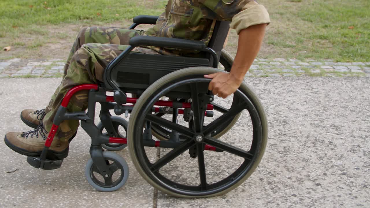 Disabled male ex soldier in wheelchair wearing camouflage