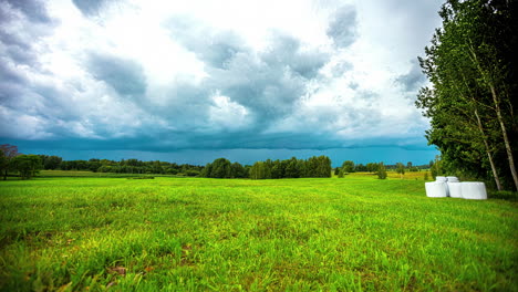 Rural-Scene-With-Hay-Bale-Roll-On-Fields-During-Harvest-Season