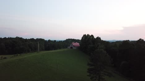 red roof horse barn in rural kentucky at sunset