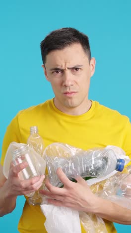 Man holding plastic bottles for recycling