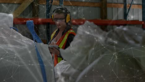 animation of network of connections over caucasian woman using tablet in warehouse