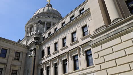 mississippi state capitol building in jackson, mississippi with tilt up from grass