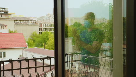 Reflexion of man on balcony clapping