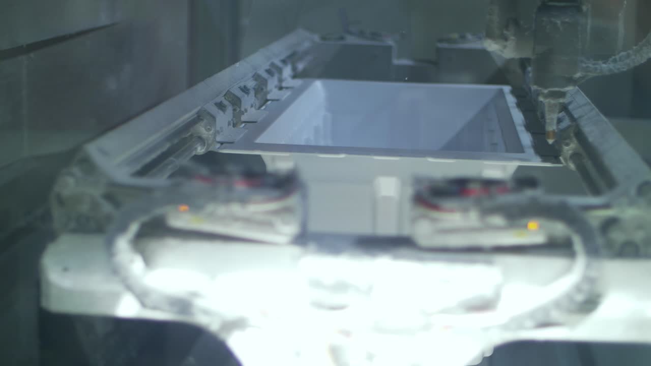 Laser cutting plastic material at factory. Household appliances industry
