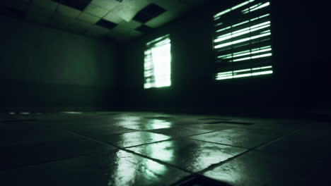 dark and empty prison cell with green tiled floor and two windows