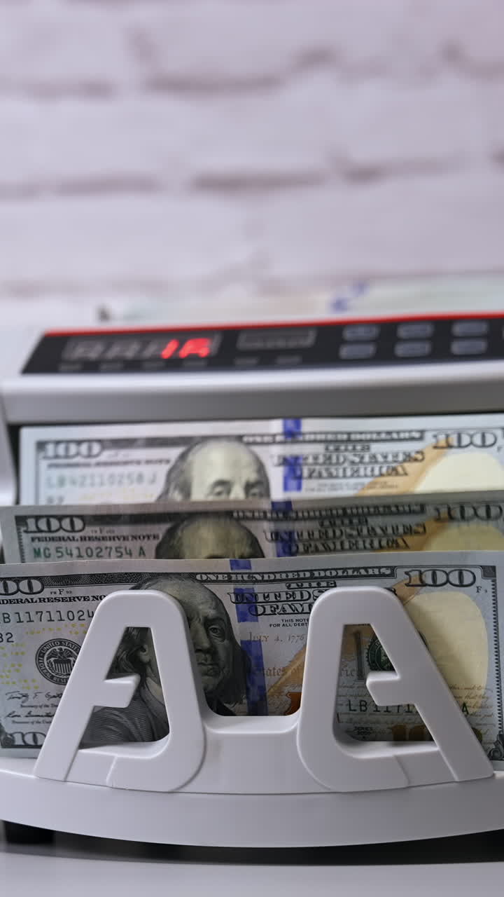 Money counting machine. Modern electronic bill counter with money, close up Vertical video
