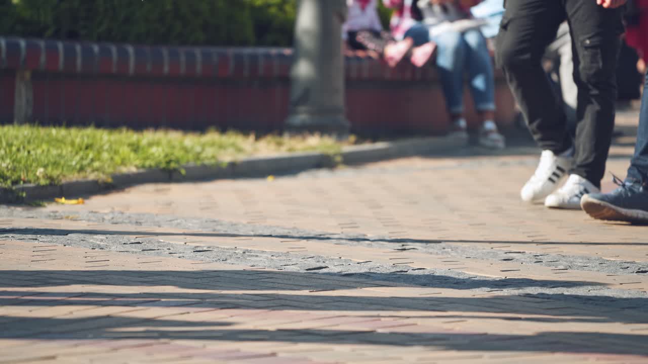 People walking on walkway. Close up of shoes walking on street