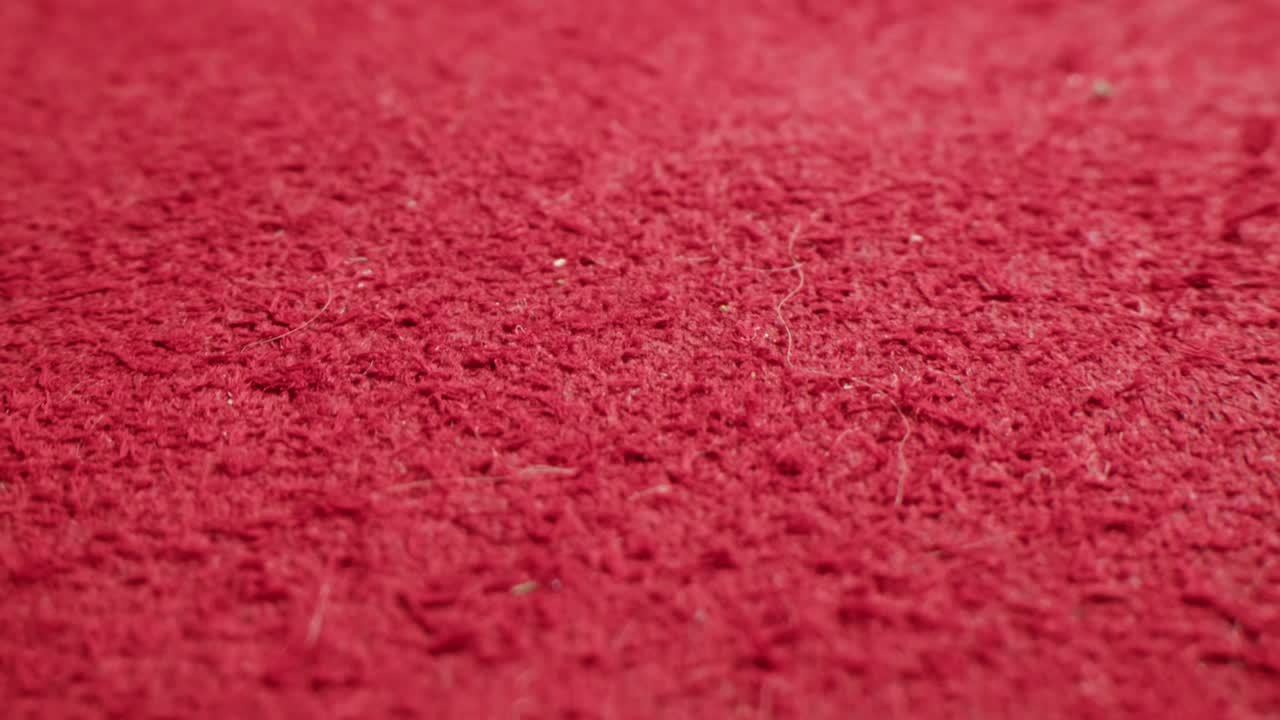Primo piano di una texture di tappeto rosso