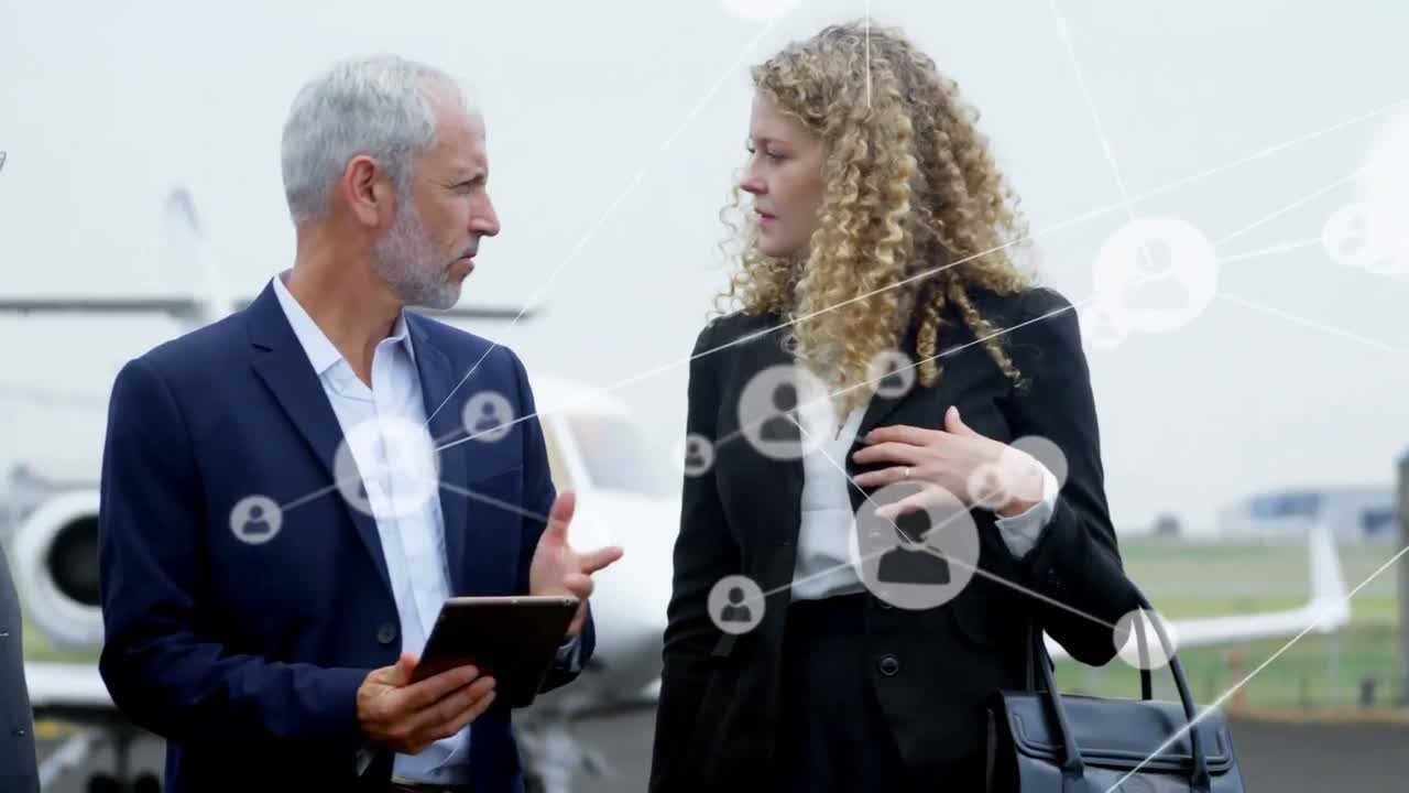 Animation of network of people icons over caucasian businessmen and businesswoman talking at airport