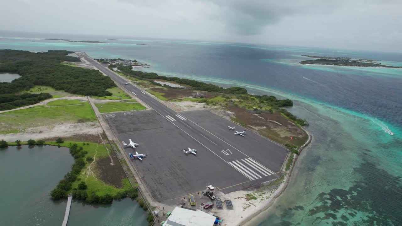 Aerial view of Los Roques airport as a plane lands on runway