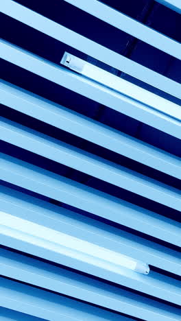 long lamps of white day light among the decorative planks on the ceiling. circle movement from low angle perspective. vertical video