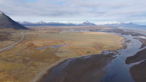 Volcanic-Sandy-soil-landscape-black-blue-rivers-mountain-Aerial-Iceland-Panorama