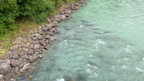 alpine river showing shoreline with blue green water