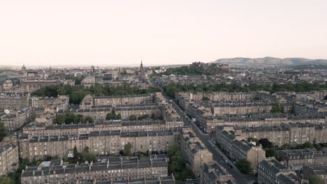 aerial rise of historic edinburgh new town residential area with edinburgh castle in background, scotland, uk