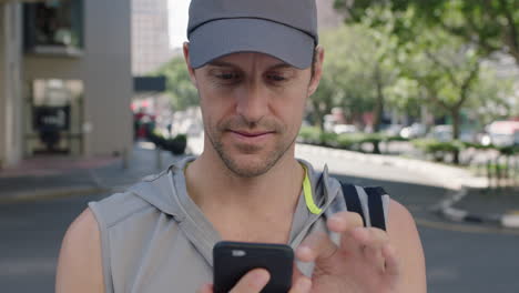 portrait-of-attractive-fit-young-man-texting-browsing-using-app-smartphone-smiling-happy-enjoying-urban-lifestyle