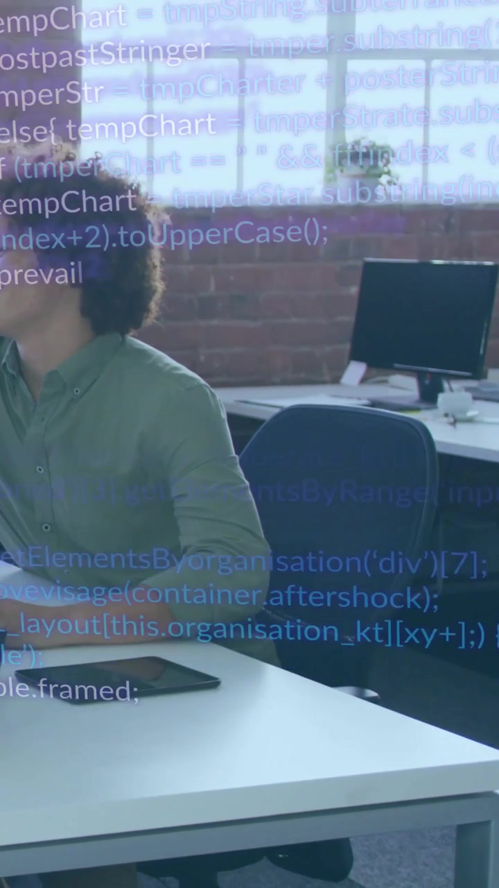 Vertical video: Developer glancing left at alert, leaning and typing as code passes tablet